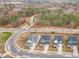 An aerial view showcases a row of homes with tree-lined streets in a neighborhood at 724 Red Arrow Dr, Knightdale, NC 27545