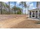 Backyard view featuring a screened-in porch and a natural landscape of trees and an undeveloped lot at 724 Red Arrow Dr, Knightdale, NC 27545