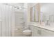 Clean bathroom features a tub, shower with white tile, white vanity, and modern fixtures at 724 Red Arrow Dr, Knightdale, NC 27545
