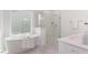 Bright bathroom with a soaking tub, sleek shower, and modern fixtures at 724 Red Arrow Dr, Knightdale, NC 27545