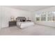 Bright bedroom with large windows, neutral colors, and plush carpeting at 724 Red Arrow Dr, Knightdale, NC 27545