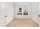 Bright bedroom with hardwood-style floors and double windows, creating a warm and inviting space at 724 Red Arrow Dr, Knightdale, NC 27545