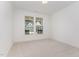 Bright, carpeted bedroom with large window, offering ample natural light and a view of the neighborhood at 724 Red Arrow Dr, Knightdale, NC 27545