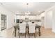 Open-concept dining area featuring modern chandelier and view into the kitchen, creating a spacious feel at 724 Red Arrow Dr, Knightdale, NC 27545