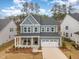 Two-story home featuring a charming front porch and a convenient two-car garage at 724 Red Arrow Dr, Knightdale, NC 27545