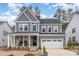 A two-story home with gray siding, a front porch, and a two-car garage at 724 Red Arrow Dr, Knightdale, NC 27545