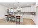 Bright kitchen showcasing pendant lighting, island with bar seating, and light countertops, offering a modern design at 724 Red Arrow Dr, Knightdale, NC 27545
