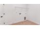 Utility room with wood floors, convenient water and dryer hookups, and door at 724 Red Arrow Dr, Knightdale, NC 27545