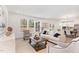 Open-concept living room with natural light, stylish furniture, and seamless flow to dining area at 724 Red Arrow Dr, Knightdale, NC 27545