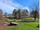 Well-manicured community park with mature trees, picnic tables, and a grassy lawn at 724 Red Arrow Dr, Knightdale, NC 27545