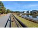 Community pond with walking path, beautiful homes are in the background at 724 Red Arrow Dr, Knightdale, NC 27545