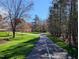 Paved walking path winding through a community park with a blend of sunny and shaded areas at 724 Red Arrow Dr, Knightdale, NC 27545