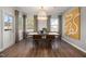 Bright dining area with contemporary decor, large windows, and hardwood flooring at 752 Ben Ledi Ct, Raleigh, NC 27603