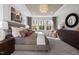 This primary bedroom is enhanced by a tray ceiling, many windows, and beautiful furniture at 752 Ben Ledi Ct, Raleigh, NC 27603