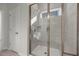 This stand up shower features a window for natural lighting and modern tiling at 752 Ben Ledi Ct, Raleigh, NC 27603
