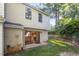 Back exterior of home with a sliding glass door and a grassy backyard at 7820 Falcon Rest Cir, Raleigh, NC 27615
