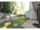 Back exterior of home with a small yard and a door leading to the unit at 7820 Falcon Rest Cir, Raleigh, NC 27615