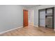 Bedroom featuring wooden floors, a closet and a wooden door at 7820 Falcon Rest Cir, Raleigh, NC 27615