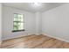 This bedroom has a window, wooden floors and a neutral wall color at 7820 Falcon Rest Cir, Raleigh, NC 27615