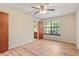 Spacious bedroom with wood floors, a ceiling fan, and a large window at 7820 Falcon Rest Cir, Raleigh, NC 27615