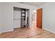 Bedroom features wooden floors, a built-in closet, and a wooden door at 7820 Falcon Rest Cir, Raleigh, NC 27615