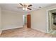 Bright bedroom with laminate floors, ceiling fan, and natural light at 7820 Falcon Rest Cir, Raleigh, NC 27615
