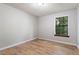Bedroom featuring wooden floors and a window with a wood trim at 7820 Falcon Rest Cir, Raleigh, NC 27615