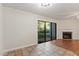 Open dining room with tiled flooring and sliding door access to the backyard area, next to the living room at 7820 Falcon Rest Cir, Raleigh, NC 27615
