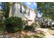 Inviting townhouse featuring neutral siding, brick accents, a covered entryway, and a neatly landscaped front yard at 7820 Falcon Rest Cir, Raleigh, NC 27615