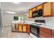 Kitchen with stainless steel appliances, wood cabinets, and tile flooring at 7820 Falcon Rest Cir, Raleigh, NC 27615