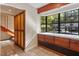 Laundry room with built-in storage, a large window, and tile floors at 7820 Falcon Rest Cir, Raleigh, NC 27615