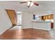 Inviting living area featuring hardwood floors, staircase and a view into the kitchen with a breakfast bar at 7820 Falcon Rest Cir, Raleigh, NC 27615