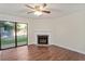 Bright living room featuring hardwood floors, a fireplace, and a sliding glass door leading to the outdoor space at 7820 Falcon Rest Cir, Raleigh, NC 27615