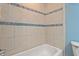 Close up of shower with tile and a blue accent border at 7820 Falcon Rest Cir, Raleigh, NC 27615