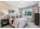 Inviting bedroom with plush bedding, decorative pillows, and natural light from a large window at 800 Emerald Bay Cir, Raleigh, NC 27610
