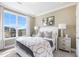 Cozy bedroom with a large window, natural light, and a neutral color palette at 800 Emerald Bay Cir, Raleigh, NC 27610