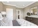 Bedroom with neutral wall paint, carpet floor, and a wooden dresser next to the bed at 800 Emerald Bay Cir, Raleigh, NC 27610