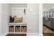 Mudroom with a built-in bench, storage baskets, and coat hooks at 800 Emerald Bay Cir, Raleigh, NC 27610