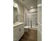 Modern bathroom with a white vanity, quartz countertop, and a glass-enclosed shower at 804 Hillfarm Dr, Wake Forest, NC 27587