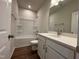 Bathroom features a shower-tub combo with white cabinets and a large mirror at 804 Hillfarm Dr, Wake Forest, NC 27587