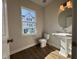 Half bathroom featuring a pedestal sink and hardwood floors at 804 Hillfarm Dr, Wake Forest, NC 27587