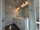 Bright bathroom featuring double sink vanity, undermount sinks, modern lighting, and a large mirror at 804 Hillfarm Dr, Wake Forest, NC 27587