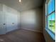 Bedroom with double door closet, carpeted floors and natural light from the window at 804 Hillfarm Dr, Wake Forest, NC 27587