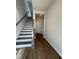 Welcoming entryway with staircase, hardwood floors, and a convenient bench for storage at 804 Hillfarm Dr, Wake Forest, NC 27587