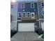 Townhome exterior showcasing a garage, driveway, and a private balcony overlooking the street at 804 Hillfarm Dr, Wake Forest, NC 27587