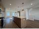 Contemporary kitchen featuring wood cabinets, stainless steel appliances, and a large island with pendant lights at 804 Hillfarm Dr, Wake Forest, NC 27587