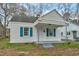 A cozy white home with blue shutters and covered porch is ready to make memories at 824 S Tillery St, Rocky Mount, NC 27803