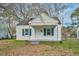 Charming white home with blue shutters and a cozy front porch is ready for move in at 824 S Tillery St, Rocky Mount, NC 27803