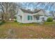 A charming white home with blue shutters and a covered porch is ready for new owners at 824 S Tillery St, Rocky Mount, NC 27803