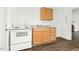 Well-lit kitchen features an oven, a wooden cabinet, and a stainless steel sink at 824 S Tillery St, Rocky Mount, NC 27803
